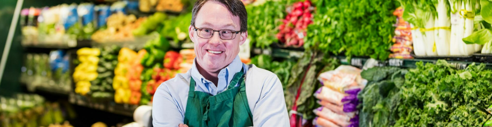 man smiling standing in grocery store