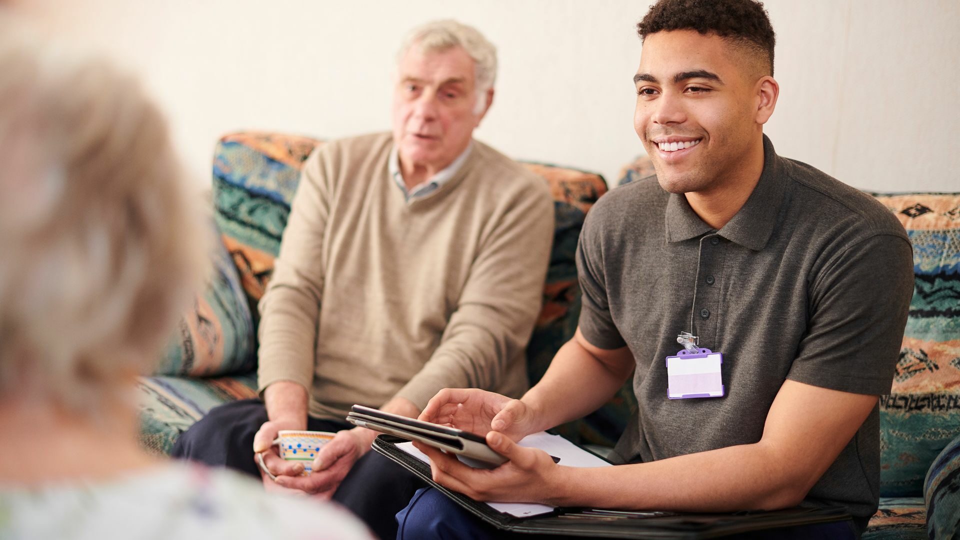 Young man speaking to a group of seniors.