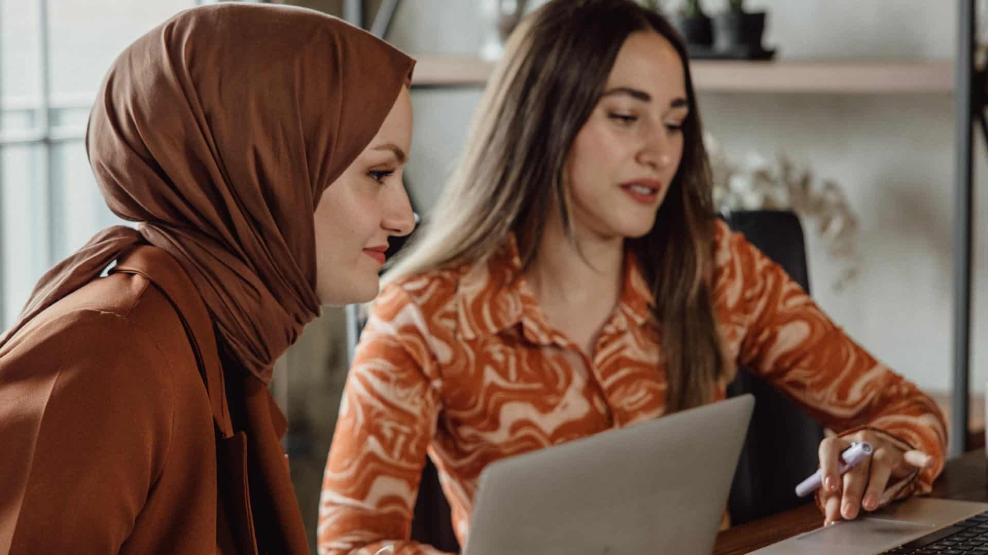 Two female office colleagues working together.