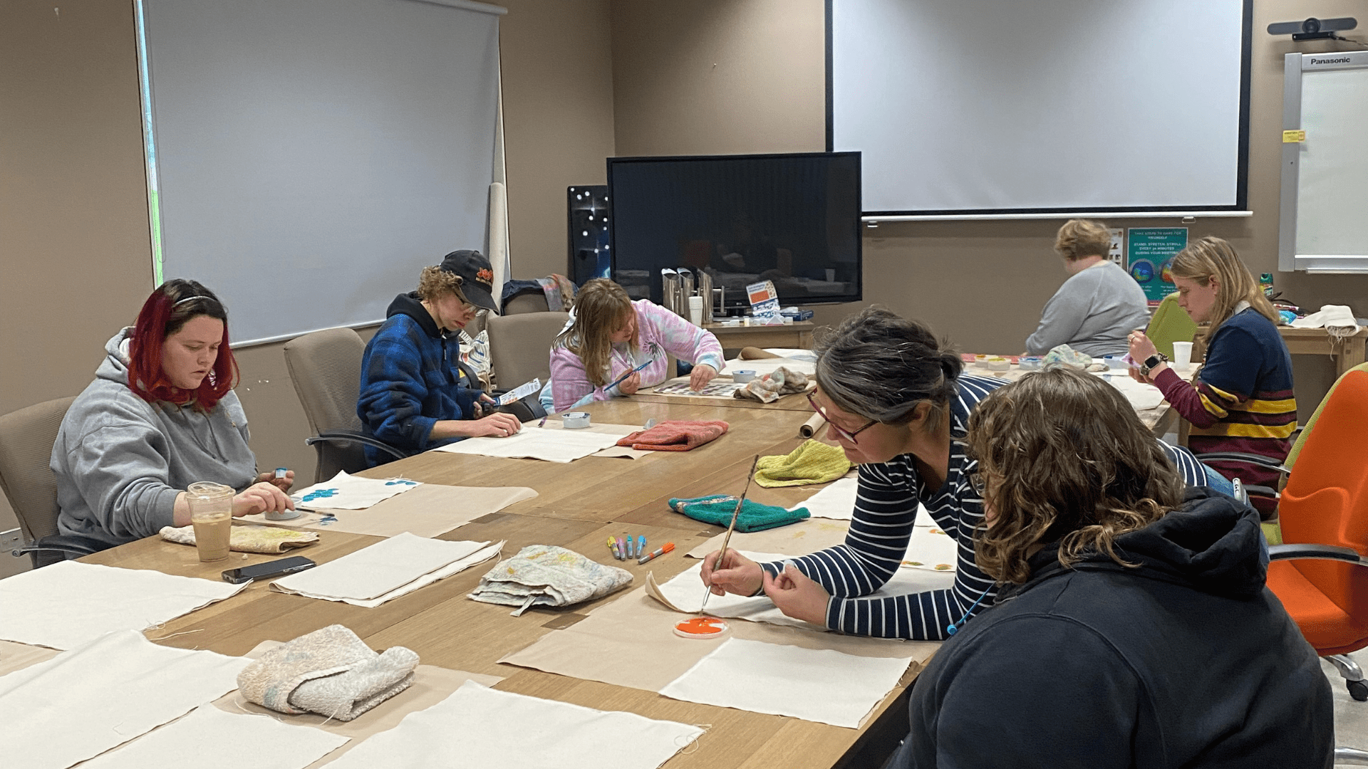 Group of women having an art session in a conference room.