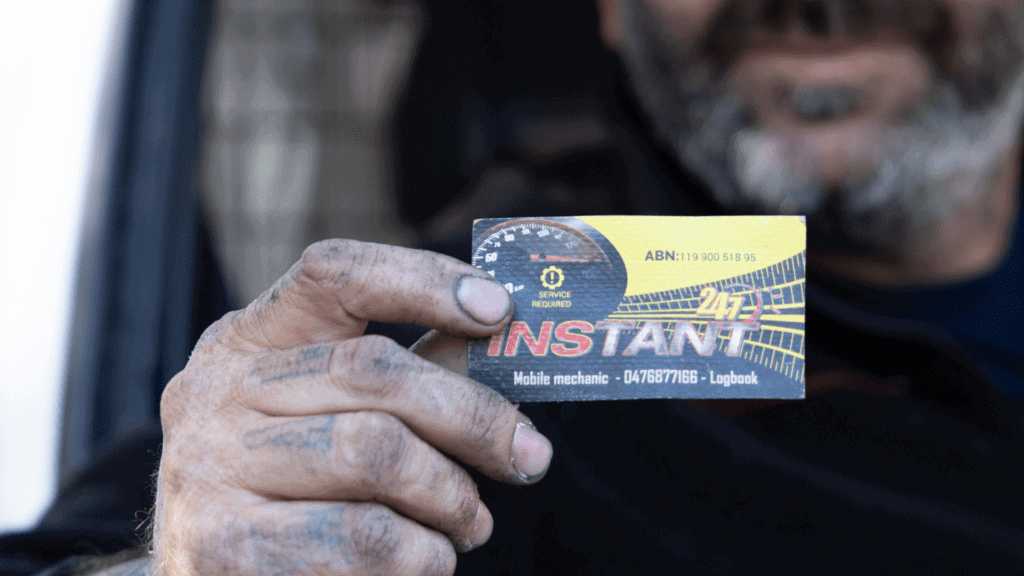 Abed holding up business card