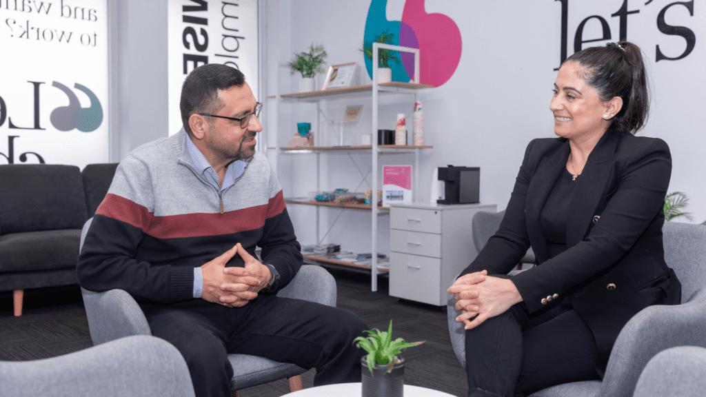 Bassam sseated across from Employment Consultant Sevan