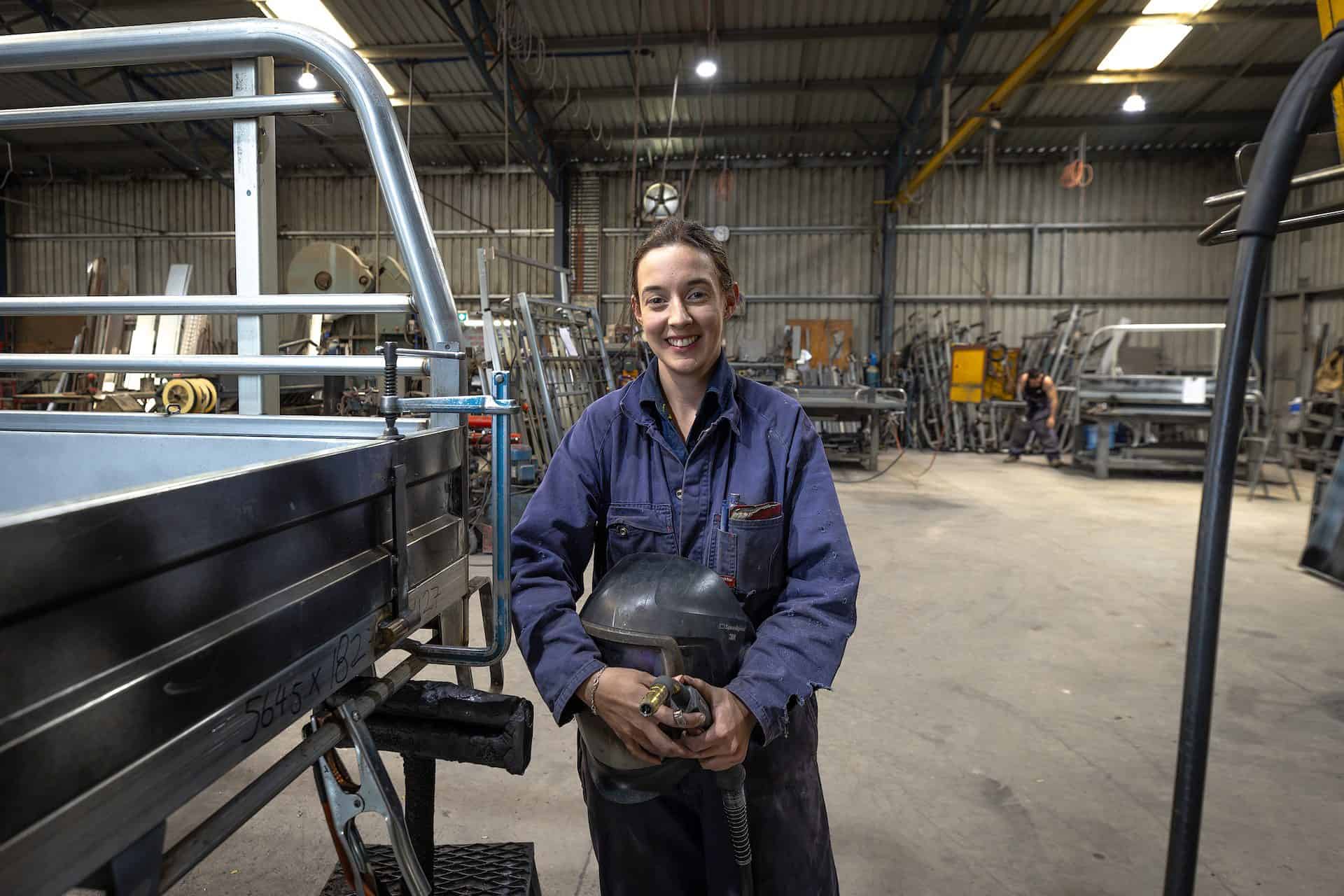 Brydie in a dark blue jumpsuit at work