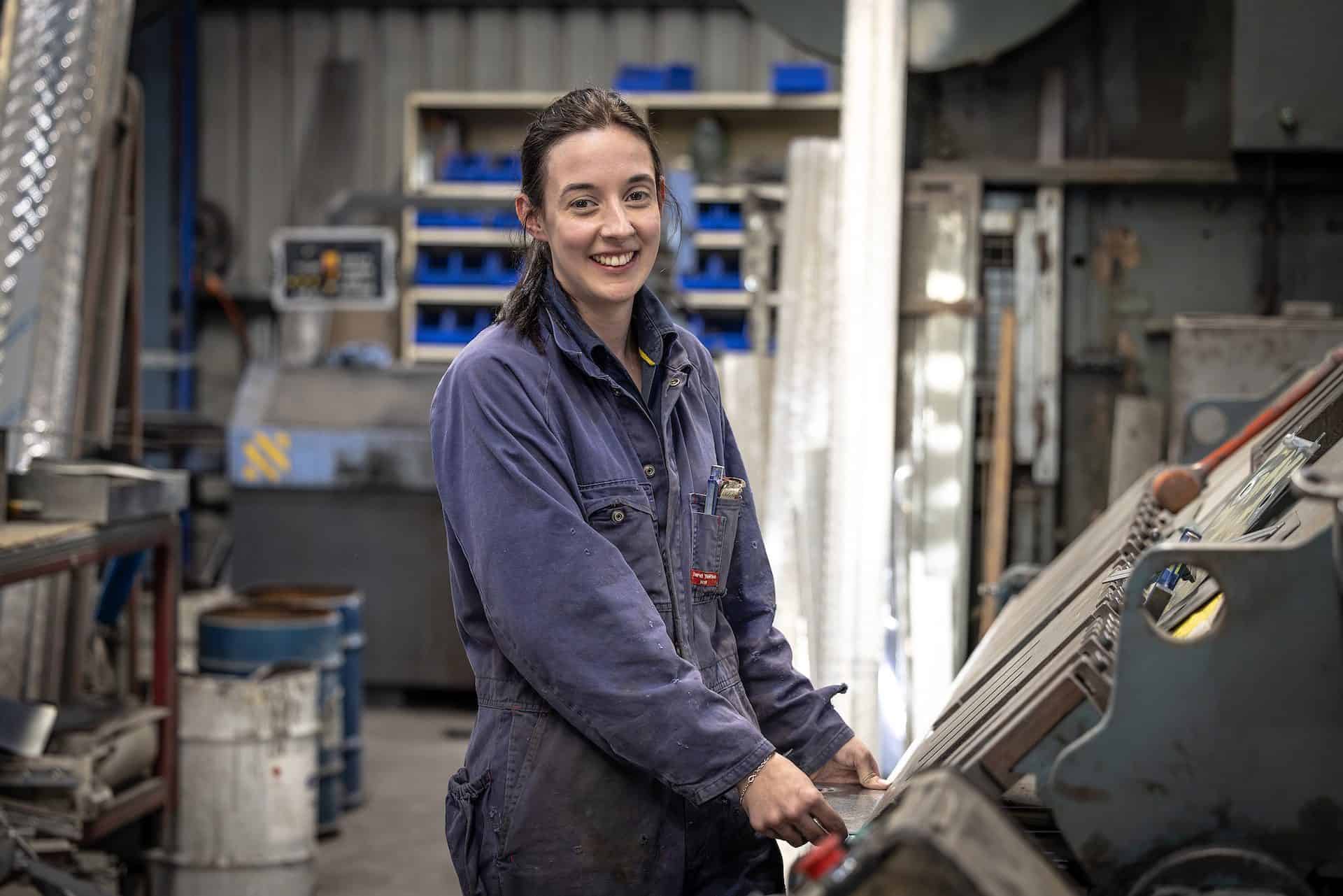 Brydie in a dark blue jumpsuit at work