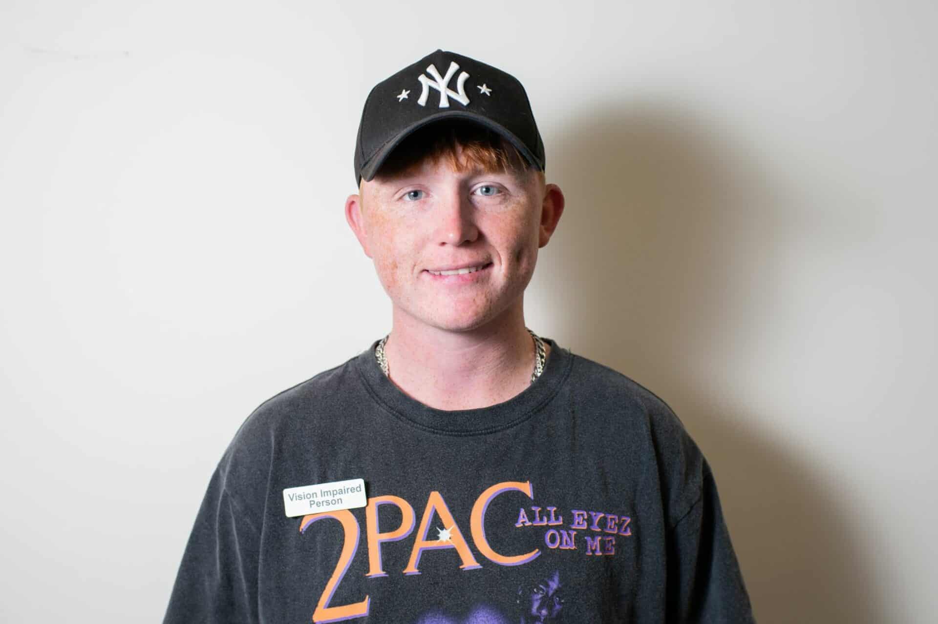 Smiling young vision impaired man.