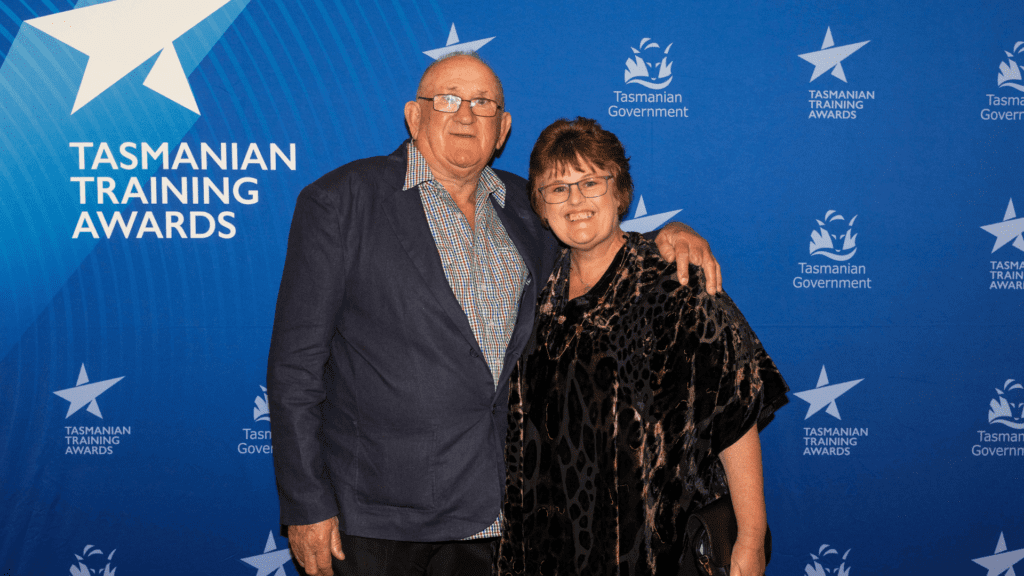A smiling couple at an awards event.