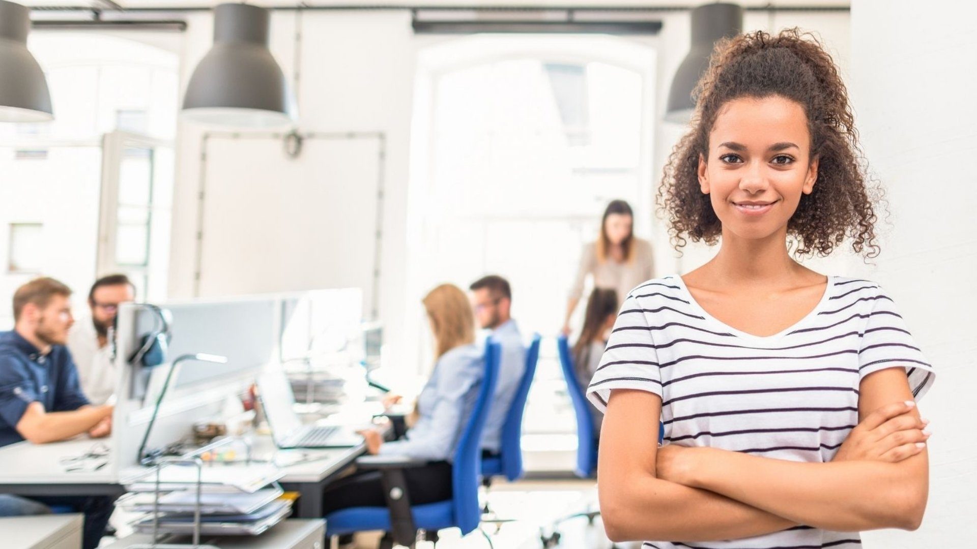 Profile of a woman standing in an office.