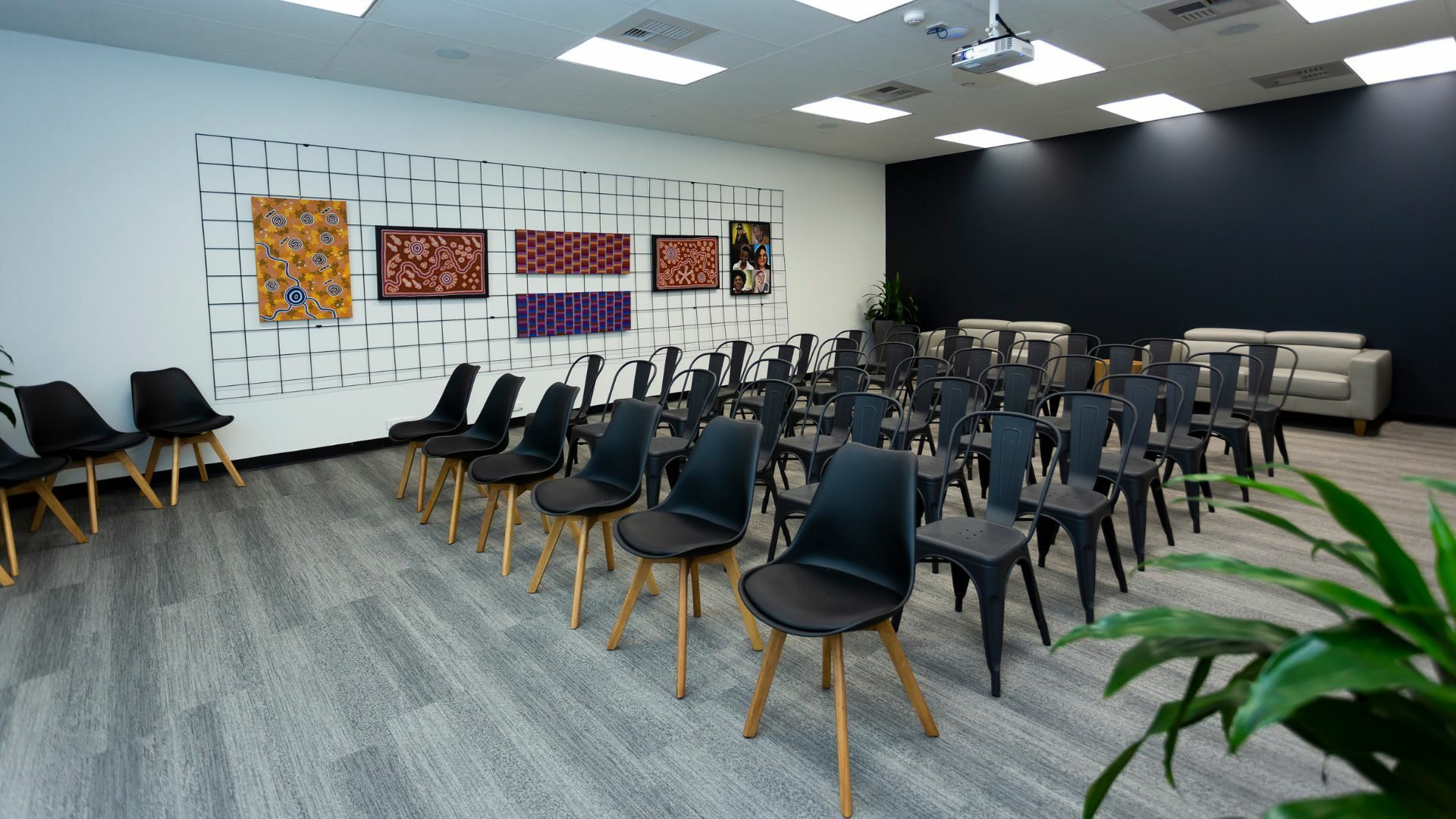 A hall with chairs and sofas.