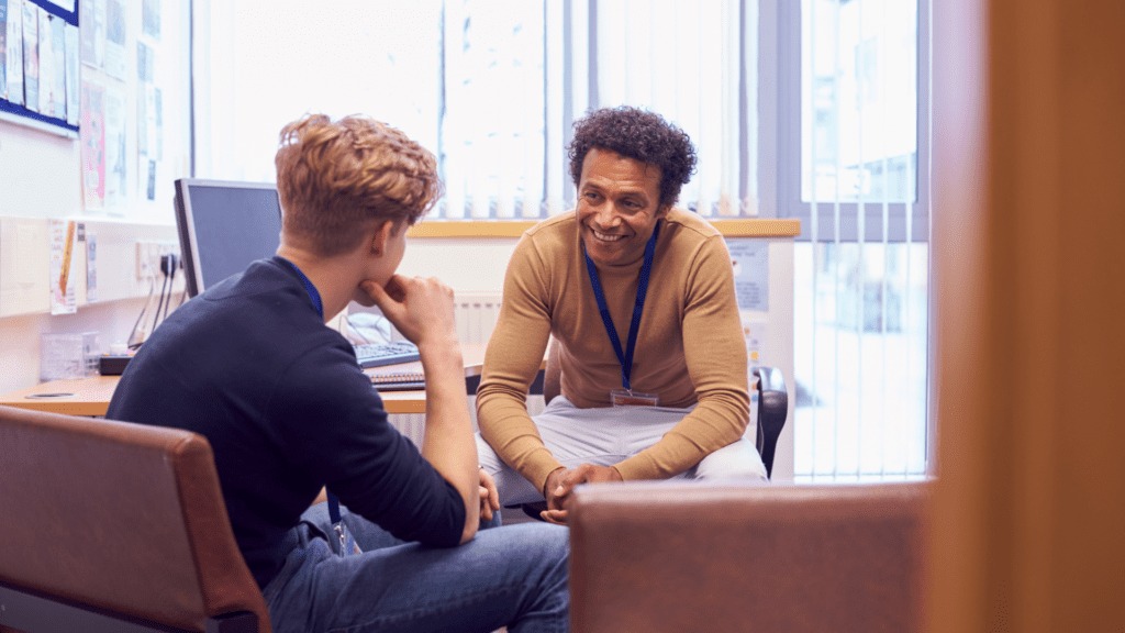 Two young people facing each other talking