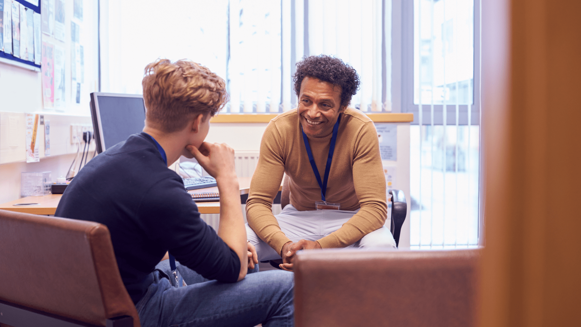 Two young people facing each other talking