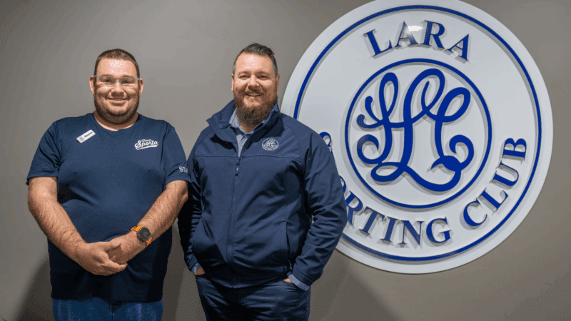 WISE customer Shannon and Brendon from Lara Sporting Club standing next to Lara Sporting Club signage indoors