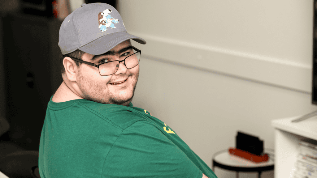 Noah smiling while playing a video game.