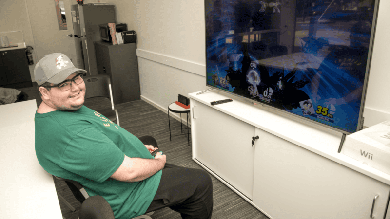 Noah smiling while playing a video game.